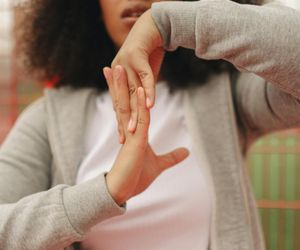 Close-up of a person hands during a stretching exercise.